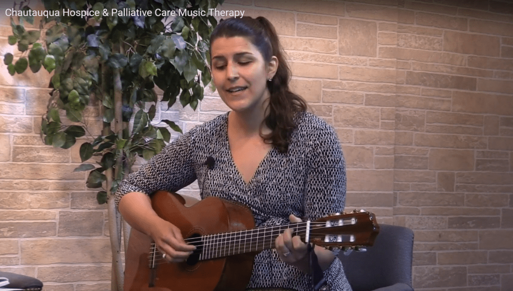 CHPC Music Therapist, Gretchen Weigle singing and playing the guitar